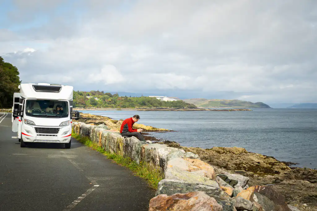Guy sat chilling outside a motorhome