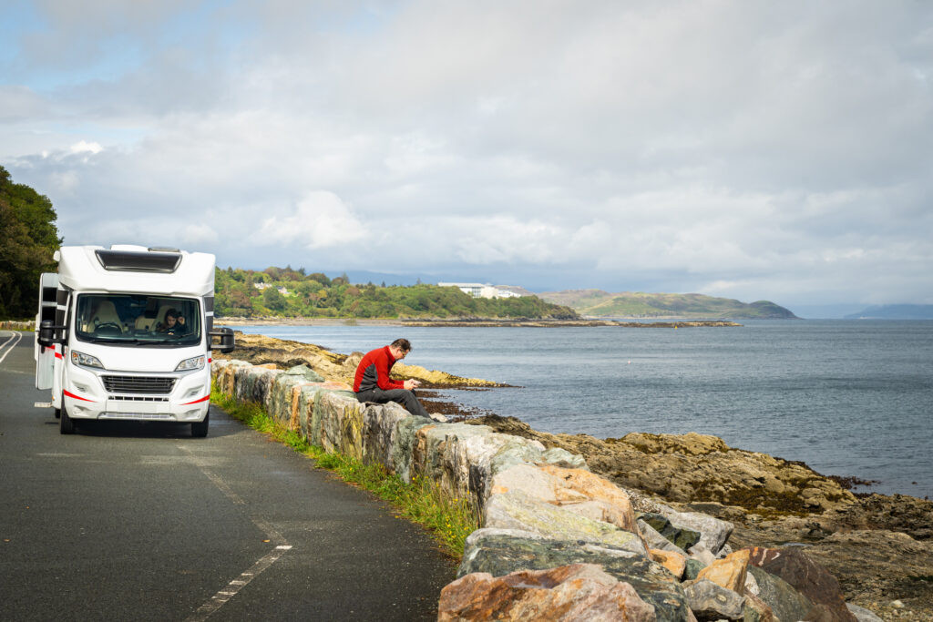 Guy sat chilling outside a motorhome